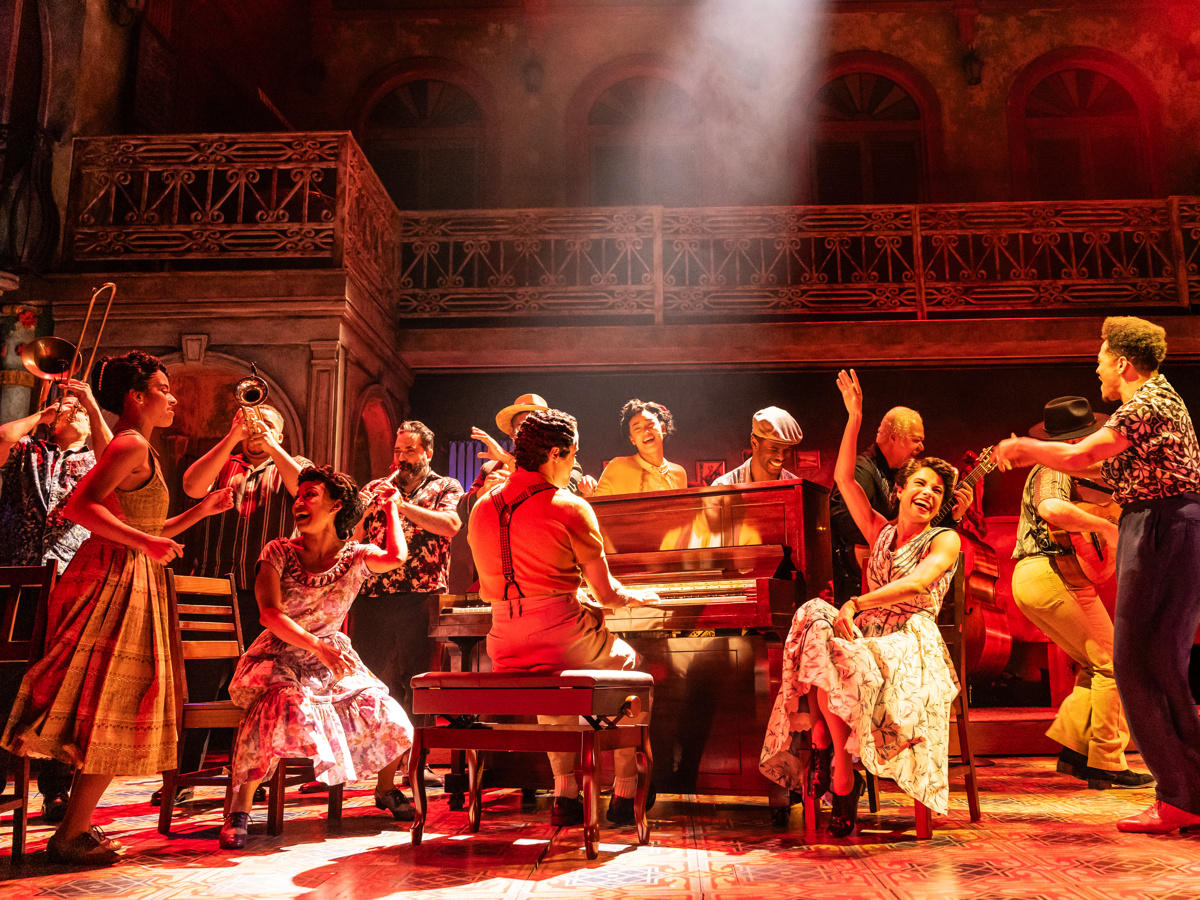 the cast of Buena Vista Social Club gathers around a piano